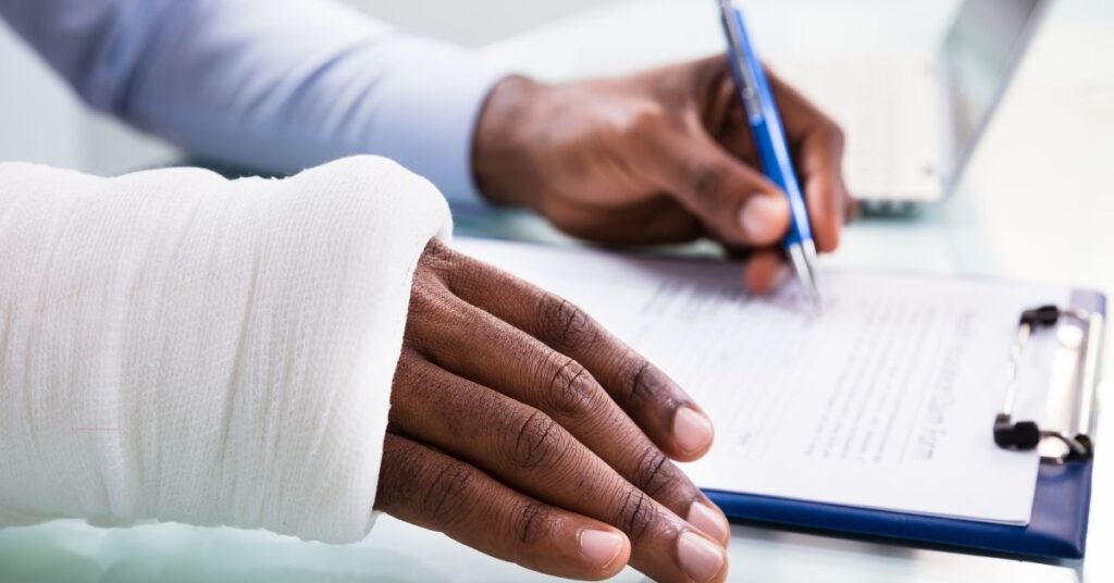 a man filling out a personal injury claim form