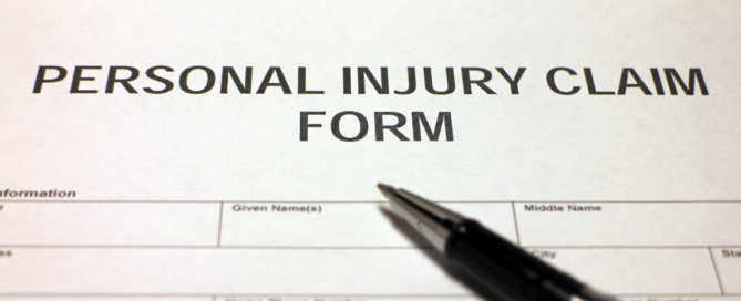 a pen on top of a personal injury claim form