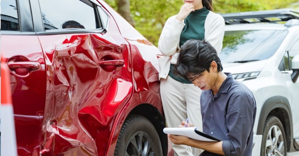 Man assessing rental car damage