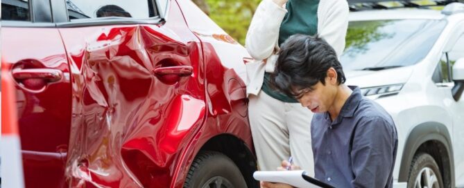 Man assessing rental car damage